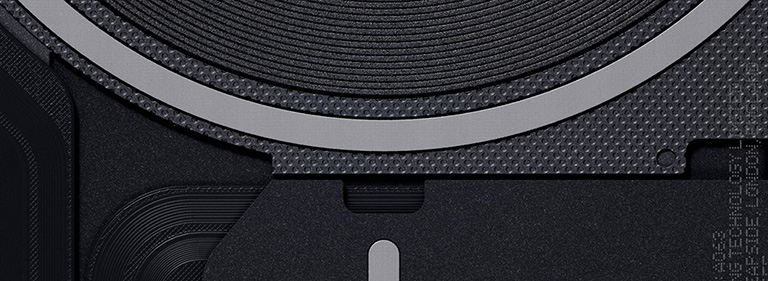 A macro, high-detail close-up of the internal components of a Nothing device, showing matte black textures, circular wireless charging coils, and precise industrial design patterns.