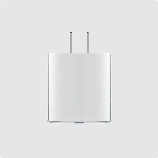 A front-facing view of a white, minimalist Nothing Power wall charger with two metallic prongs.